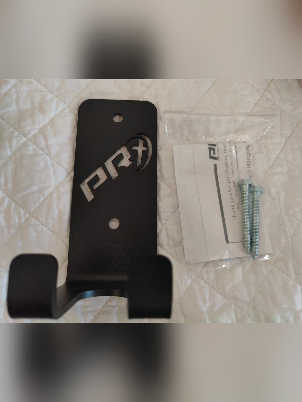 PRx Performance wall-mounted barbell storage rack for organizing gym gear.